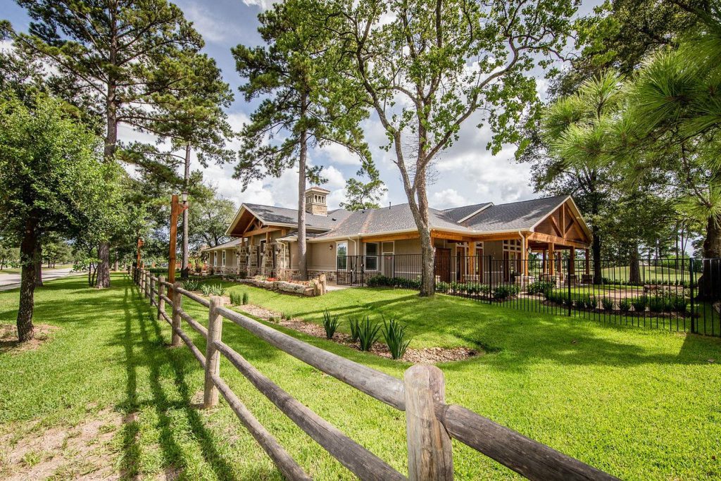 Exterior view of the assisted living facility with trees