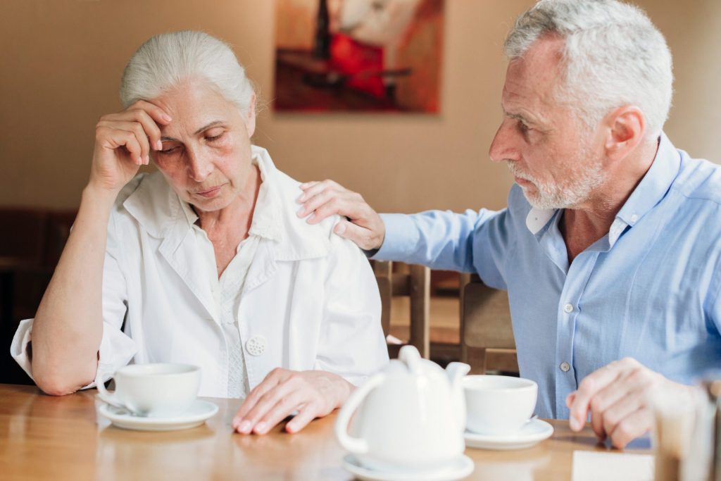 Two residents having a serious conversation over tea.