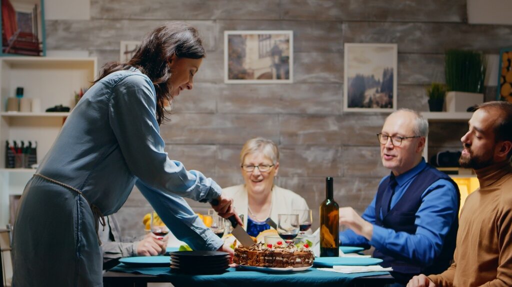 Staff serving food to residents during a meal.
