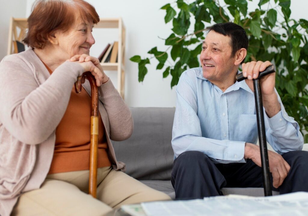 Two residents enjoying conversation in a cozy common area.