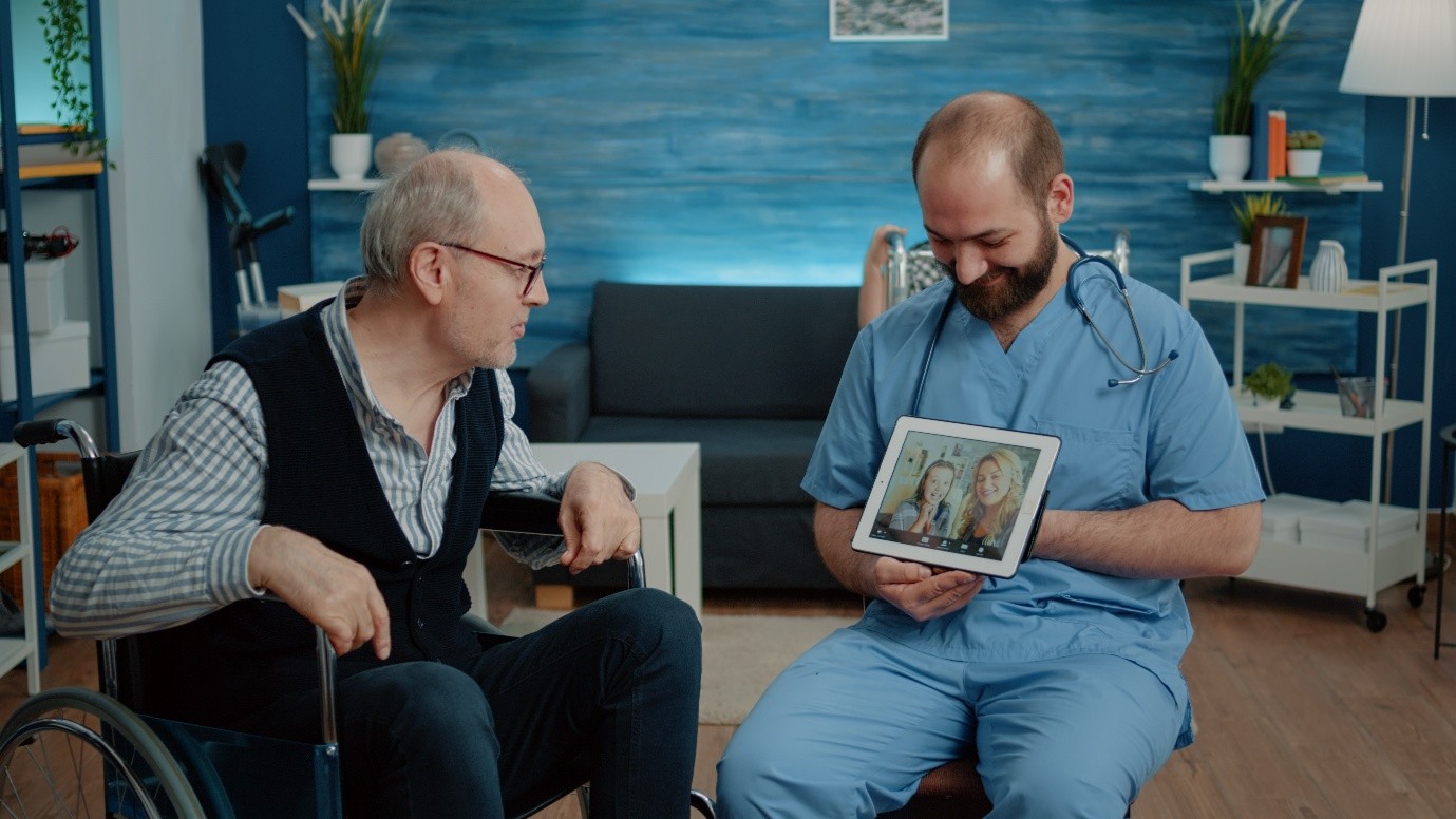 Care staff showing a tablet to a resident