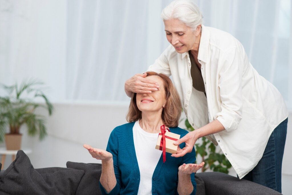 A caregiver surprising a resident with a gift