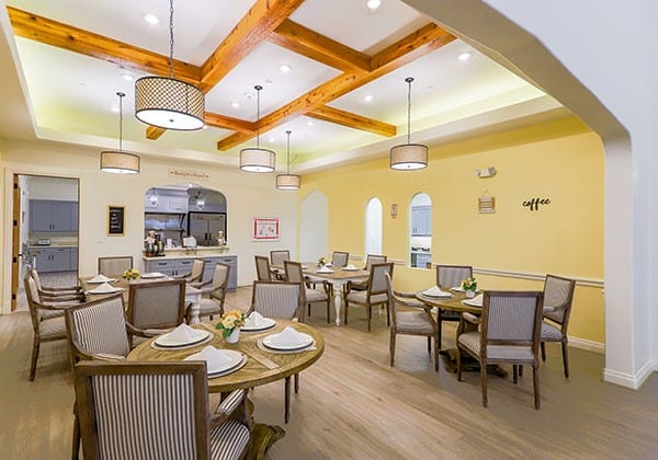 Dining area with tables and chairs set for a meal