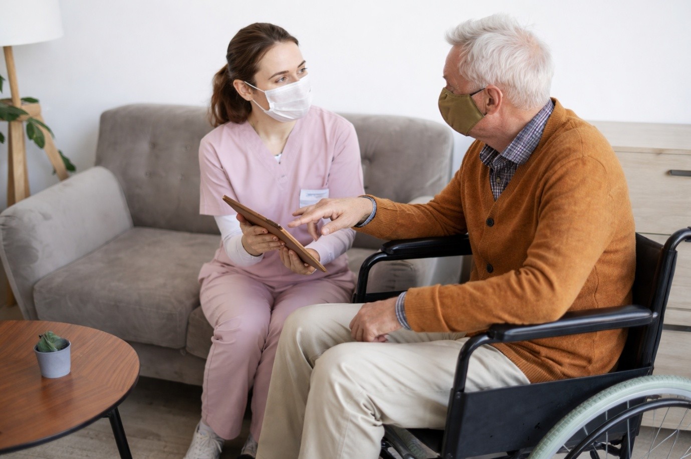 Caregiver interacting with a resident in a warm setting.