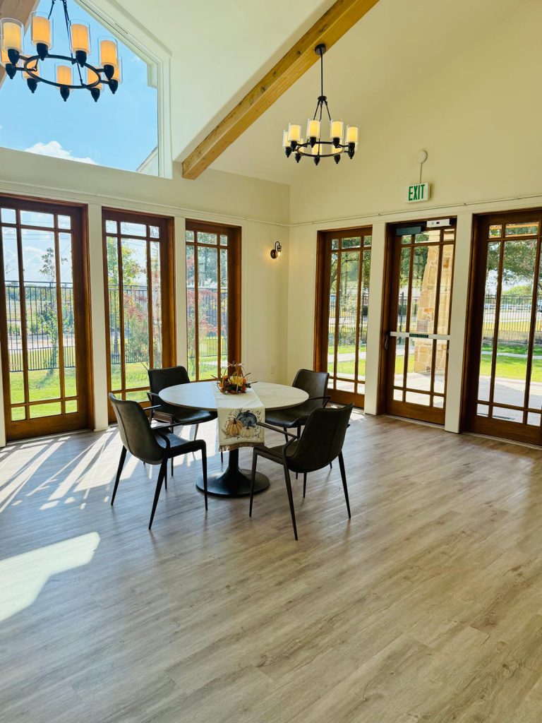 Bright common area with large windows and a table