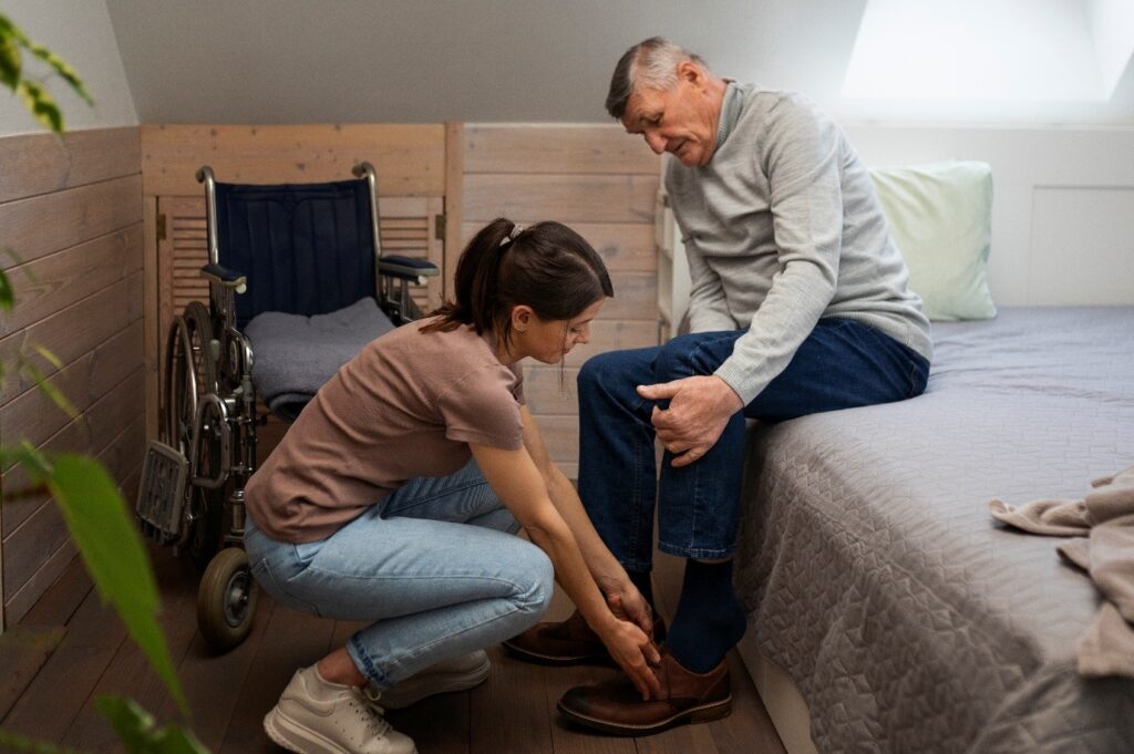 Caregiver assisting a resident with shoes