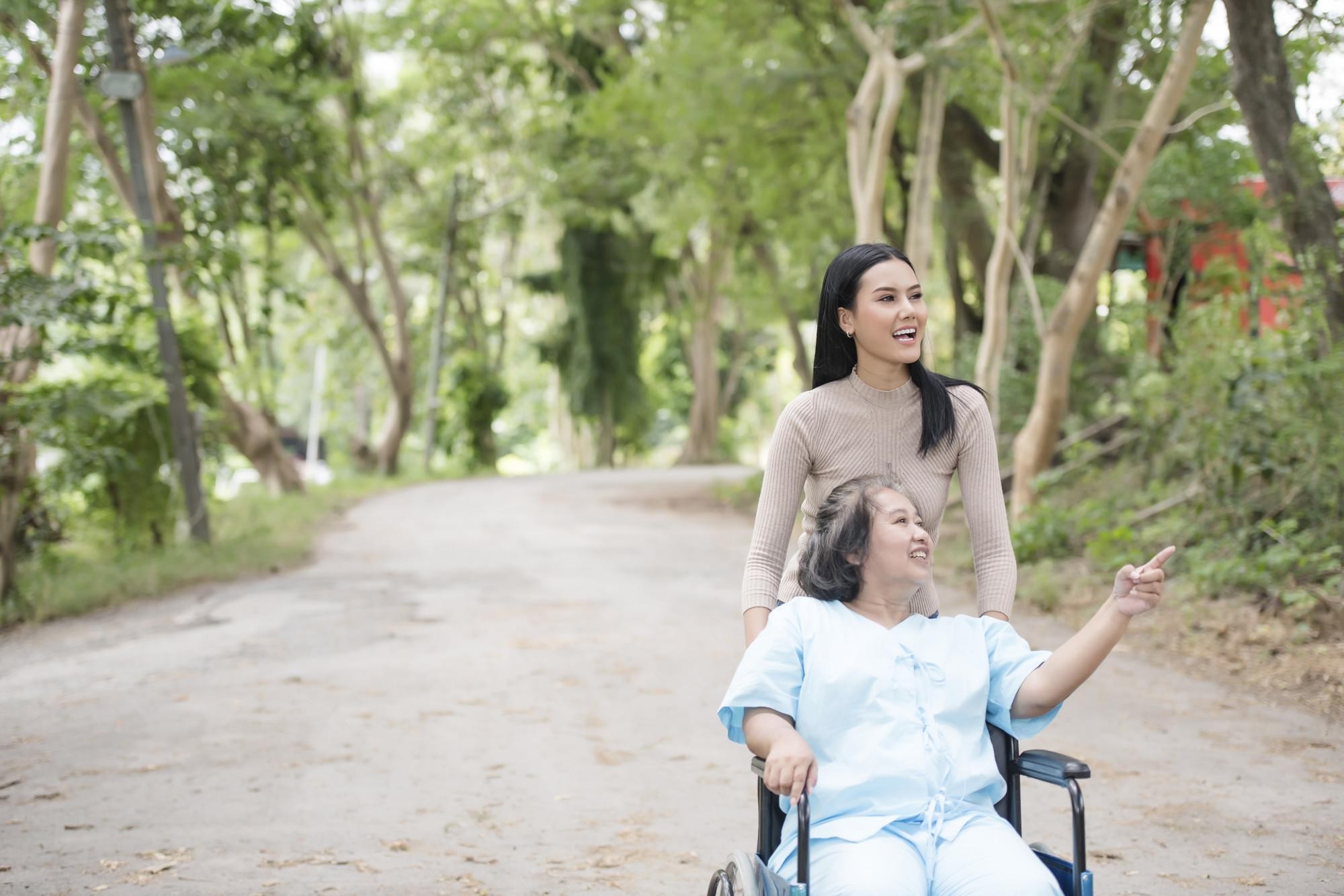 Caregiver and resident enjoying nature outdoors.