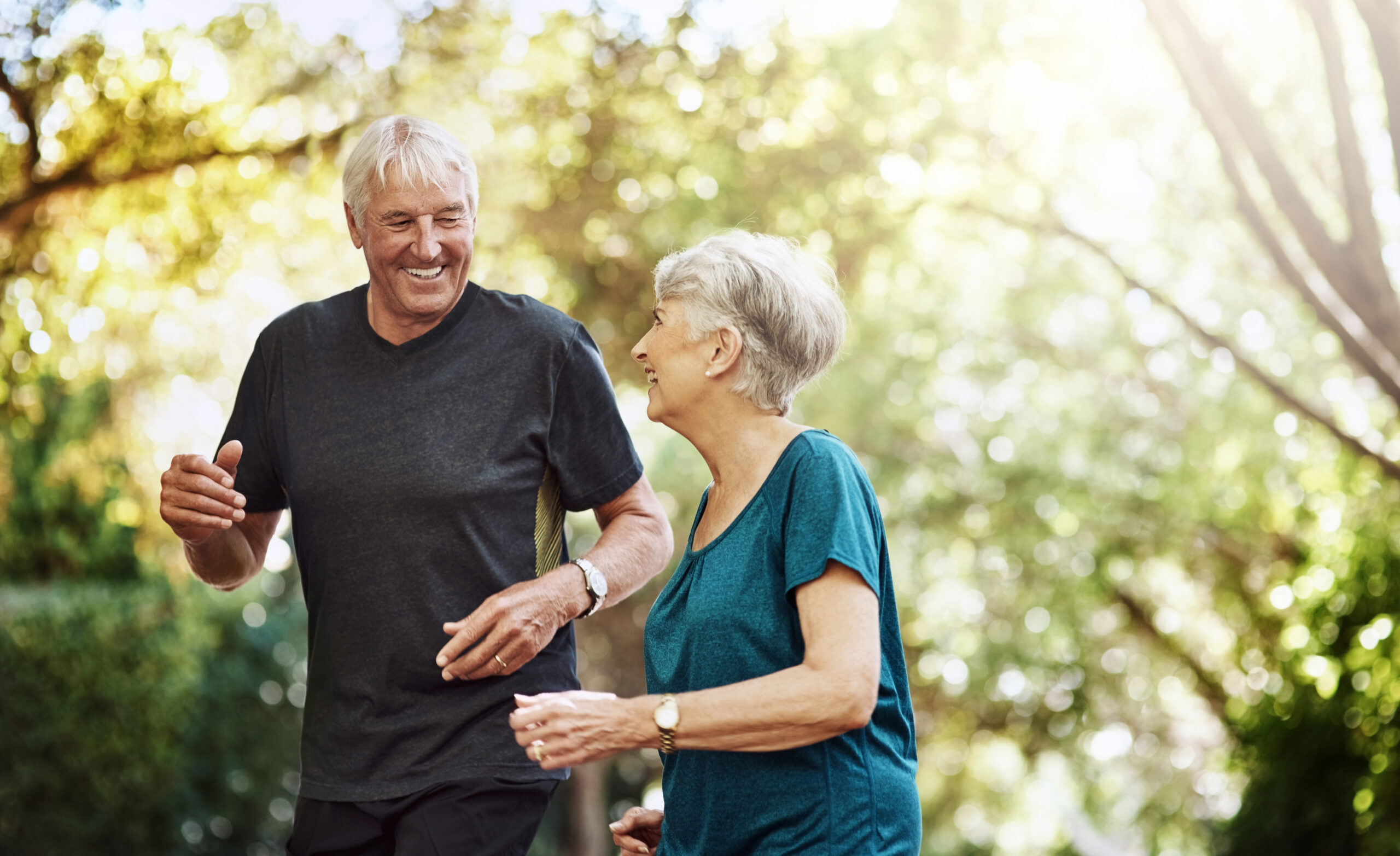 Two senior residents walking together outdoors