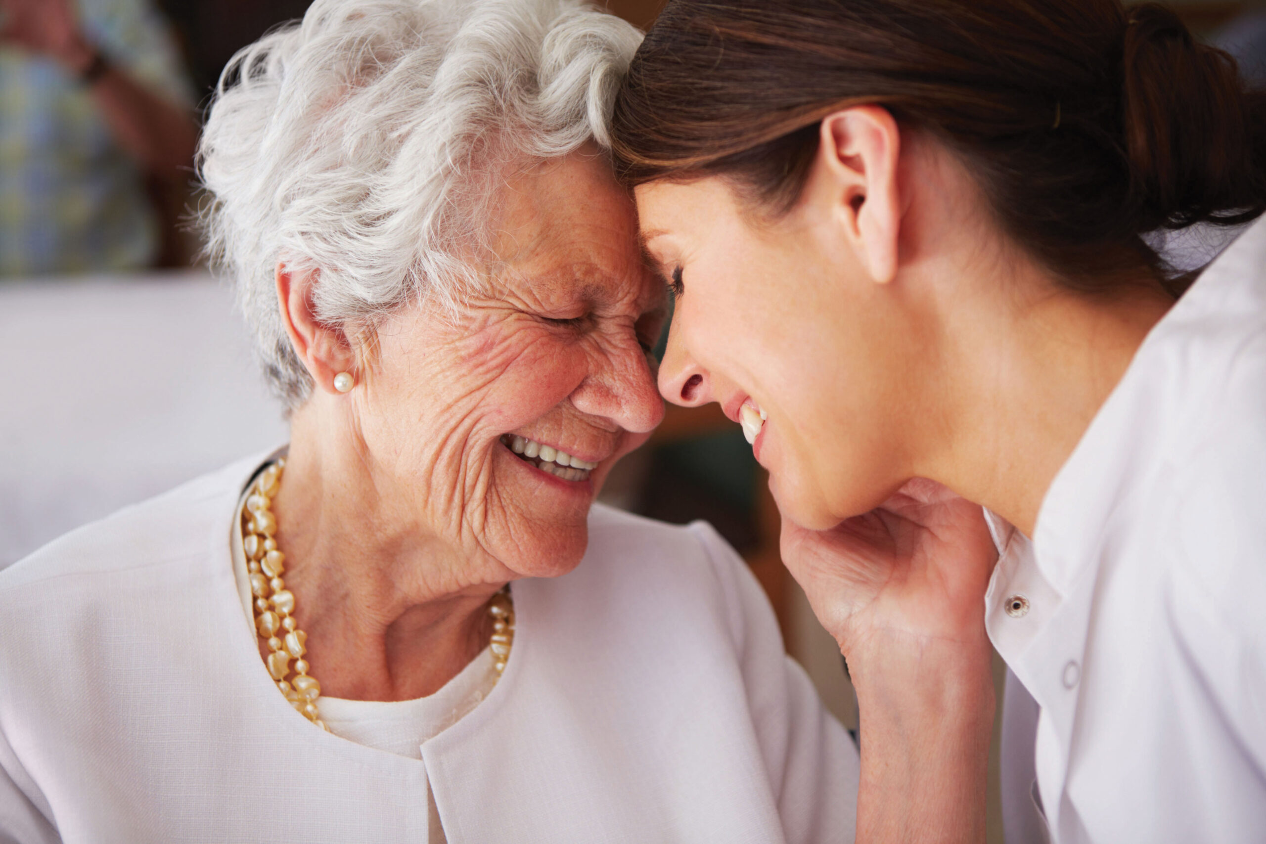 A caregiver and resident sharing a joyful moment