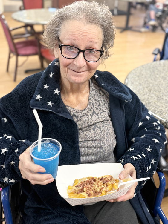 Resident enjoying food and a drink in the common area
