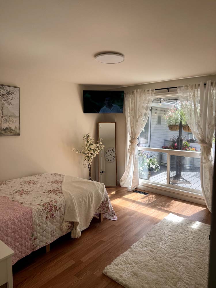 Cozy resident room with a bed and patio access