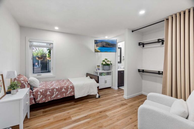 Bright and modern resident room with a bed and seating area