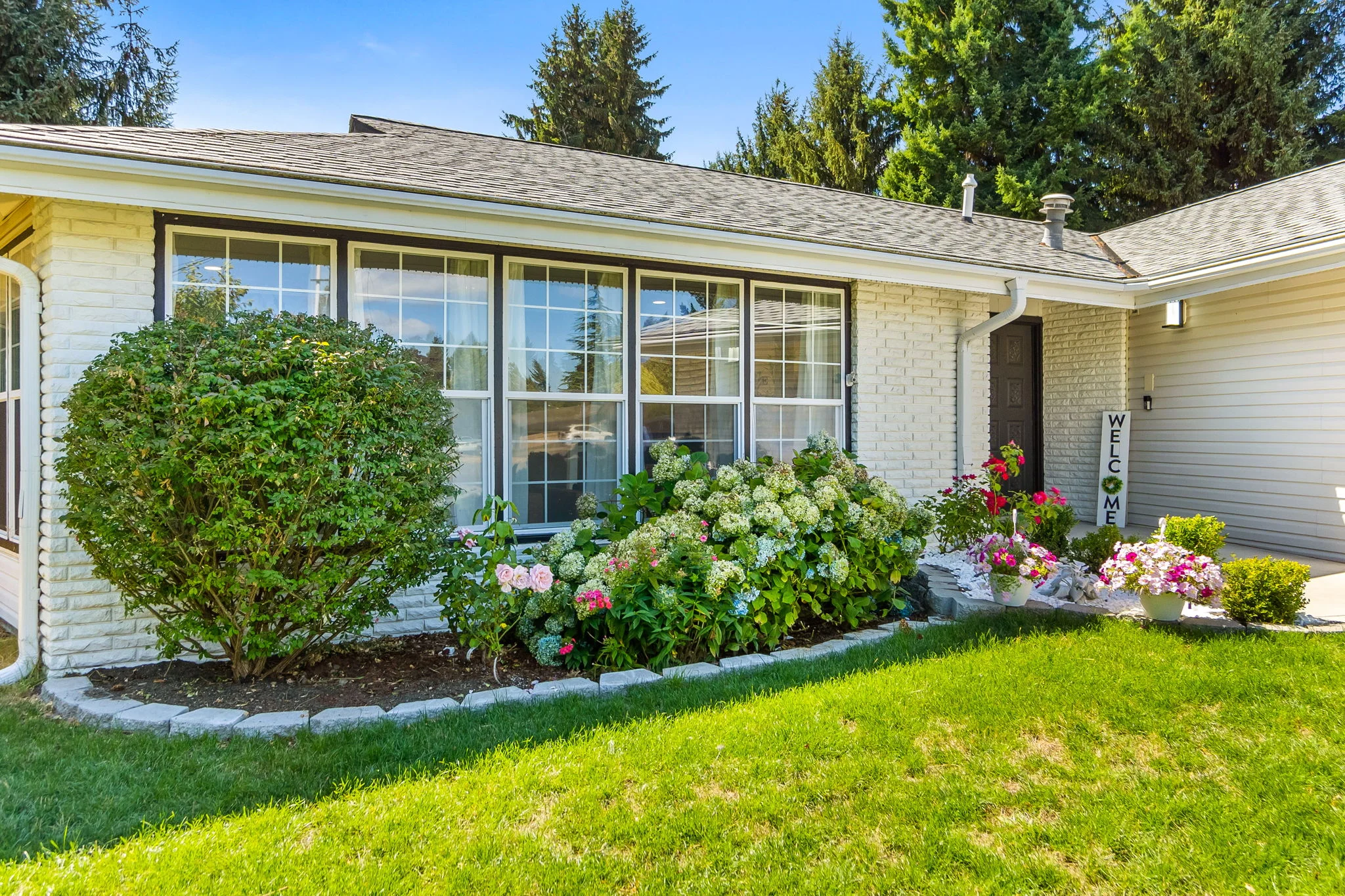 Building exterior with welcome sign and landscaped garden