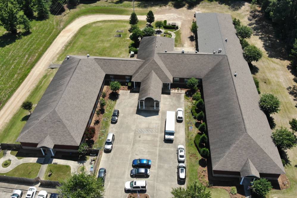 Aerial view of the building complex with surrounding greenery