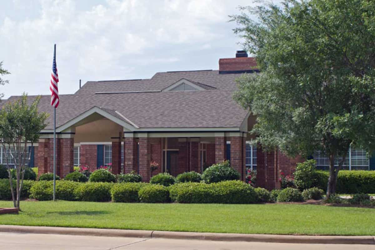 Exterior view of Azalea Estates facility featuring landscaped grounds