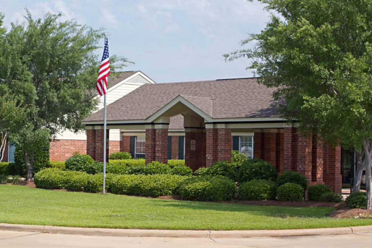 Exterior view of a senior living facility with landscaped grounds