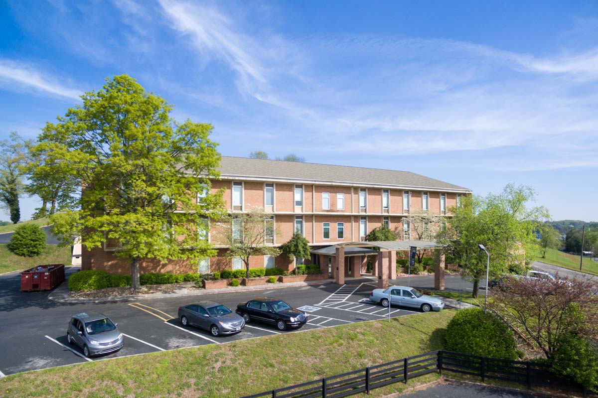 Exterior view of Azalea Estates with parking and landscaping