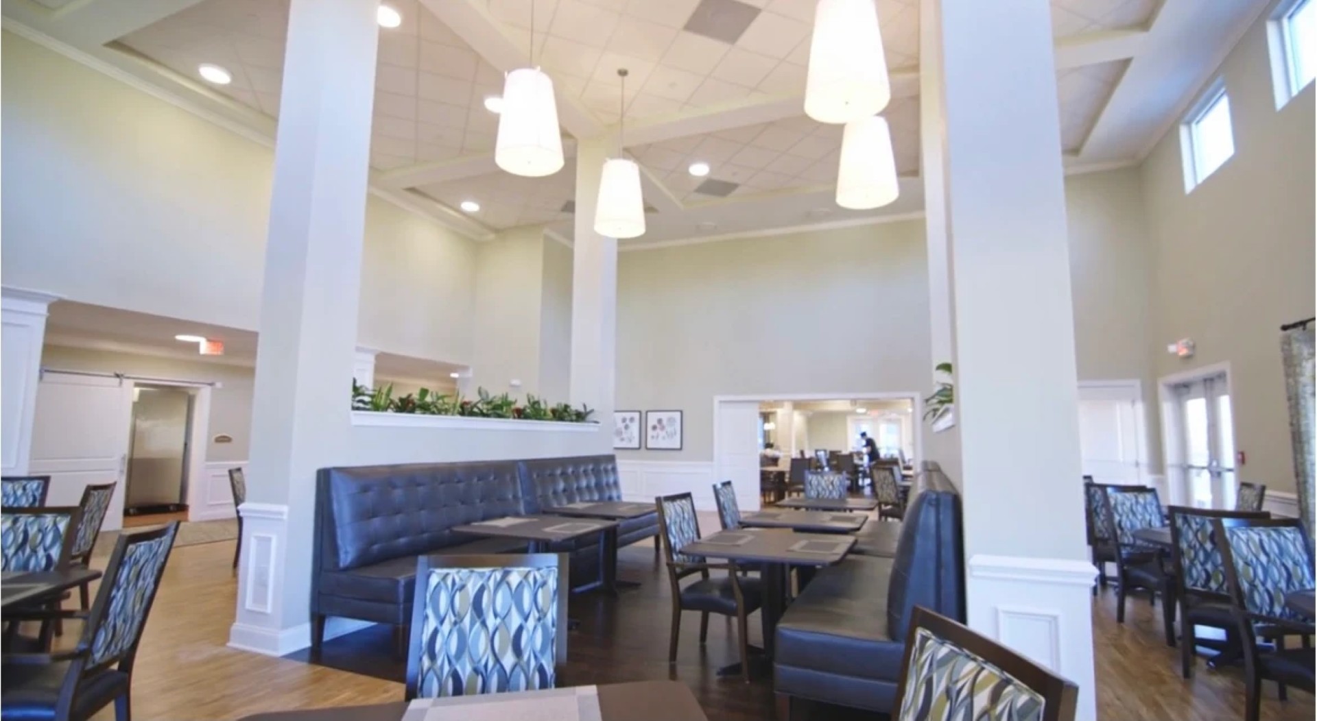 Bright dining area with modern furniture and high ceilings