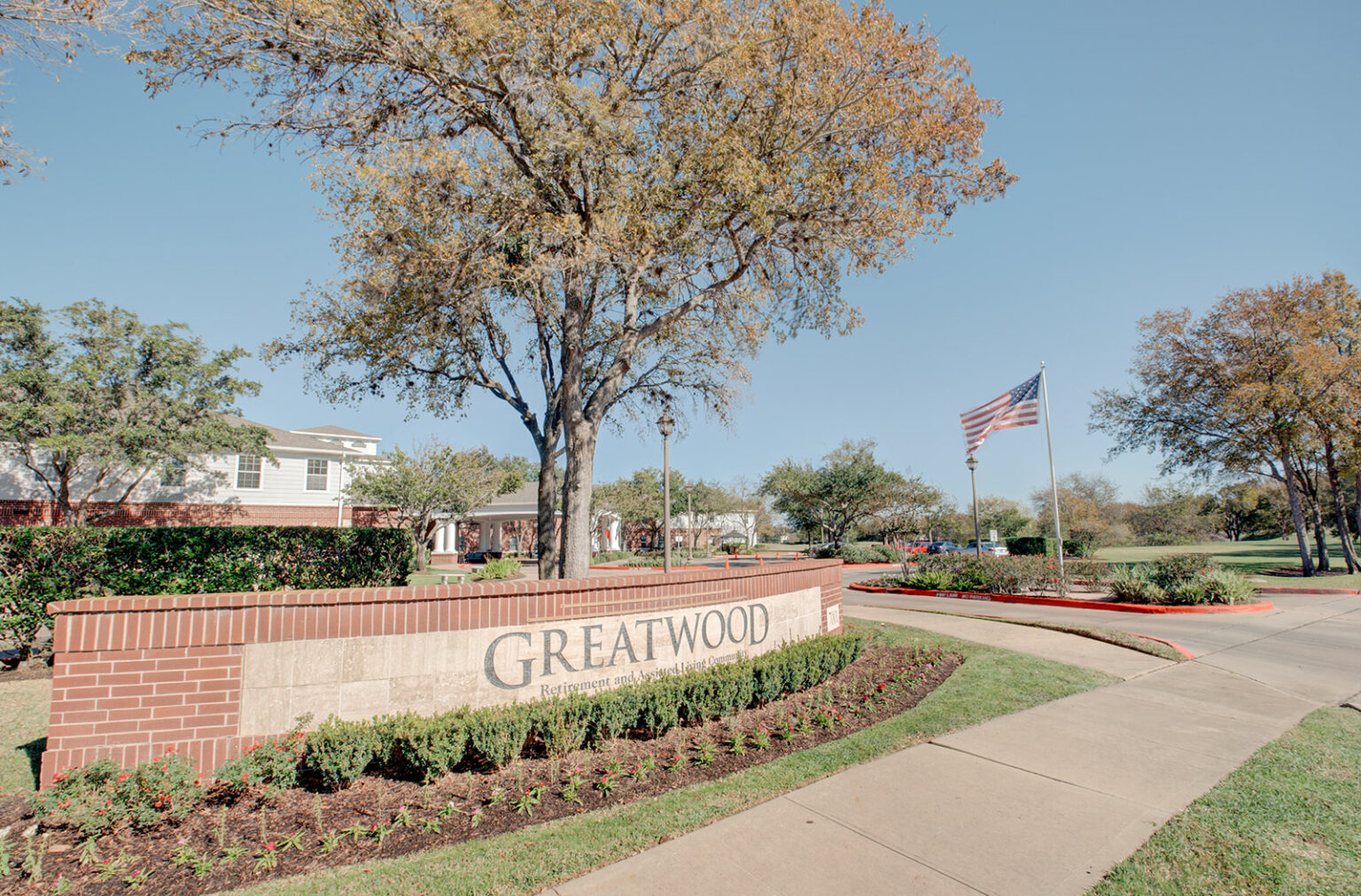 Entrance sign and landscaping at the facility
