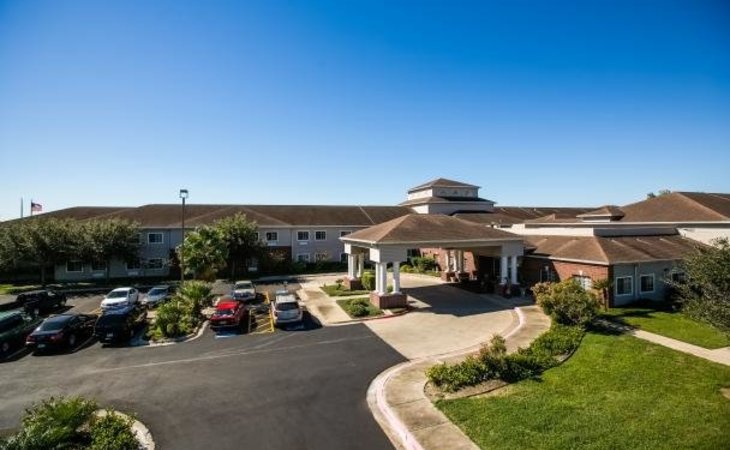 Exterior view of Azalea Estates with garden and parking area