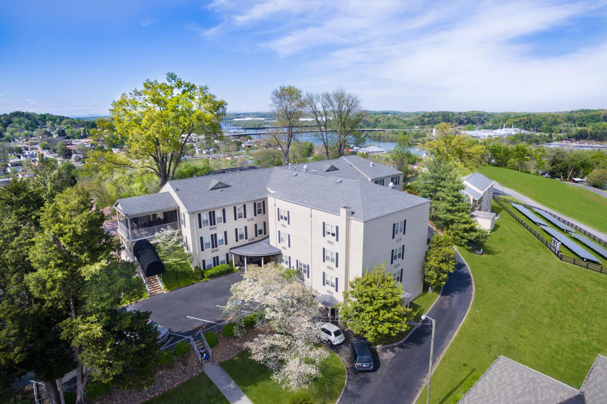 Aerial view of the facility with green spaces