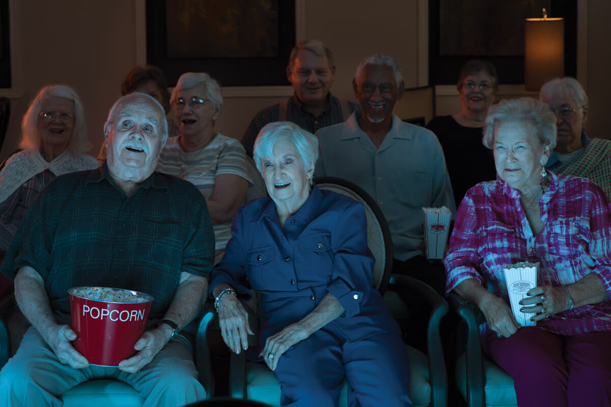 Residents enjoying a movie night with popcorn
