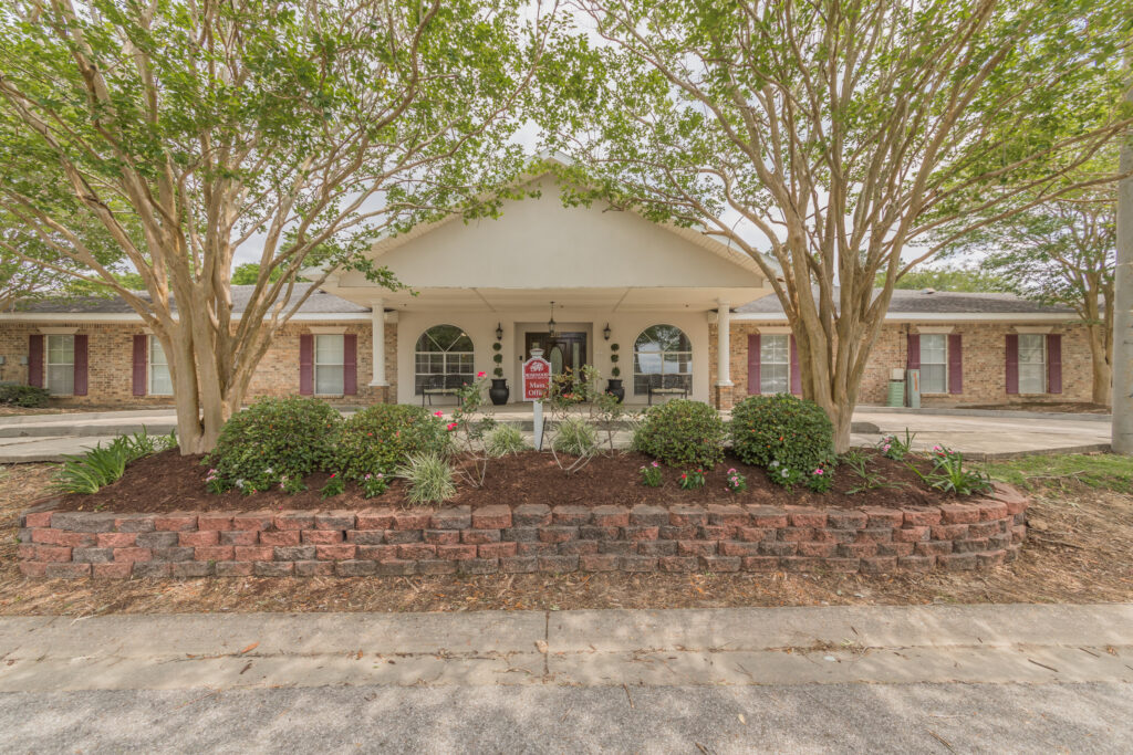 Front exterior of Azalea Estates of Monroe with landscaping