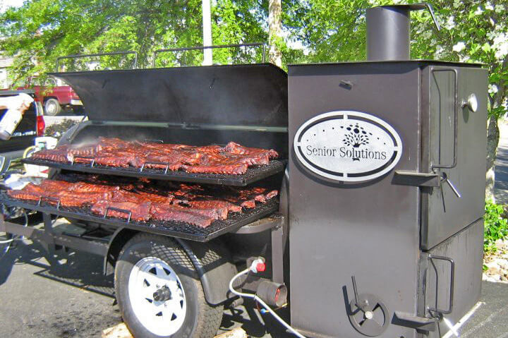 Smoker trailer with barbecue ribs being cooked