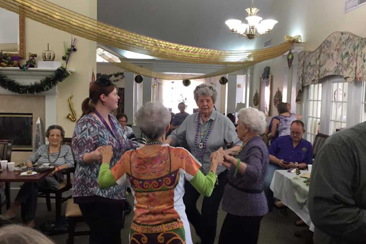 Residents and staff enjoying a dance in a common area