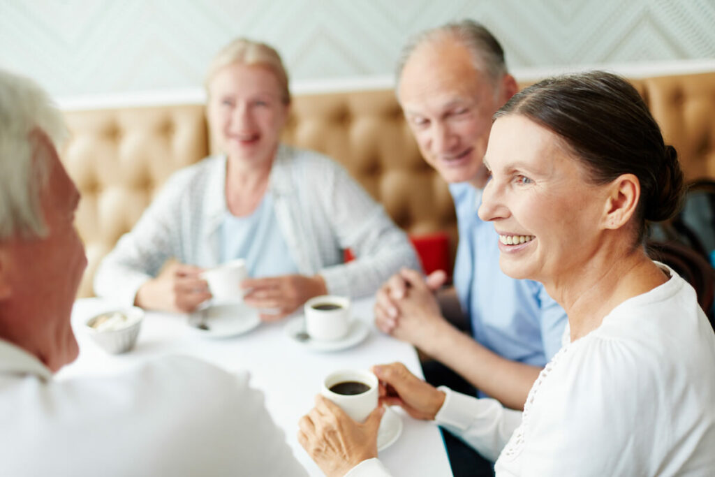 Residents enjoying coffee and conversation at a table