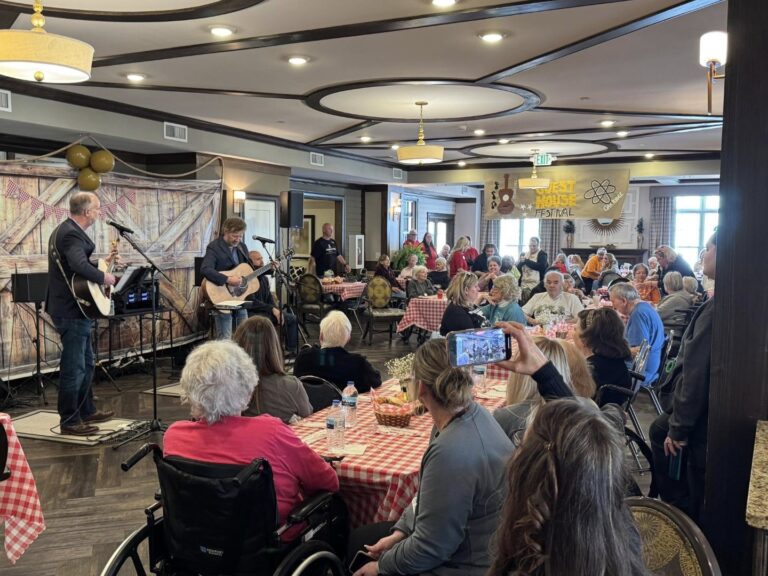 Residents enjoying a musical performance in a lively common area