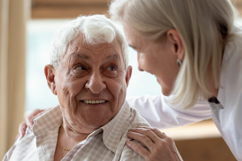 Senior resident and caregiver sharing a joyful moment