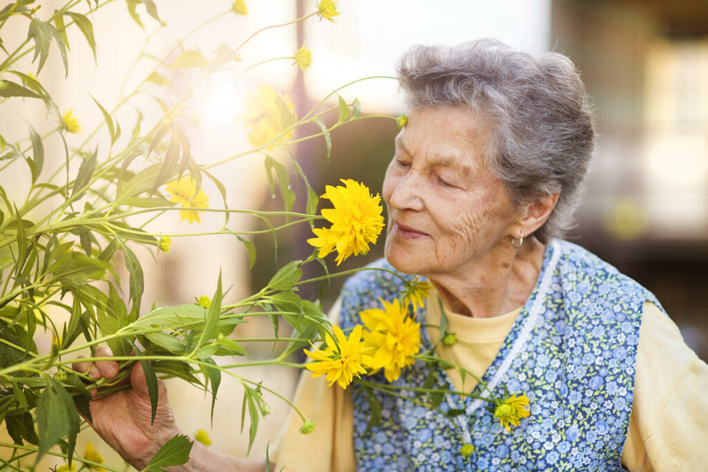 Resident enjoying flowers in the garden