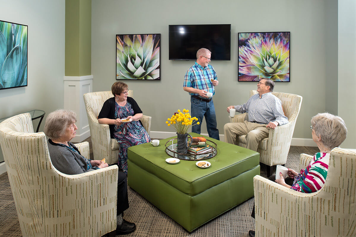 Residents enjoying conversation in a cozy lounge area