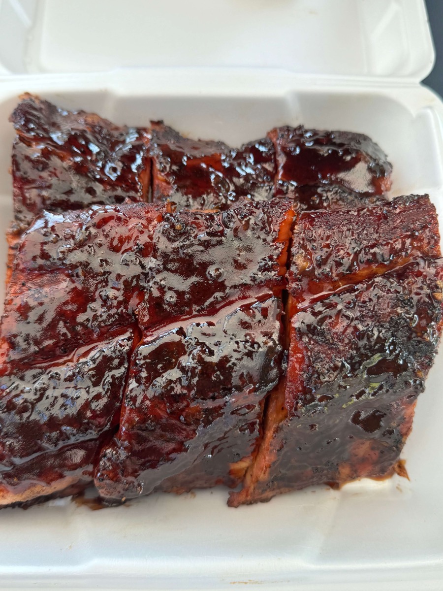 Close-up of glazed barbecued meat in a container