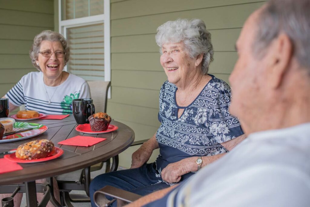 Residents enjoying pastries and coffee on a patio