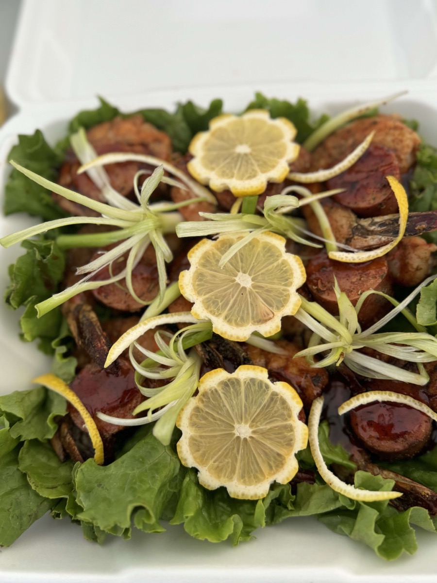 A beautifully arranged plate of food with lemon slices and greens