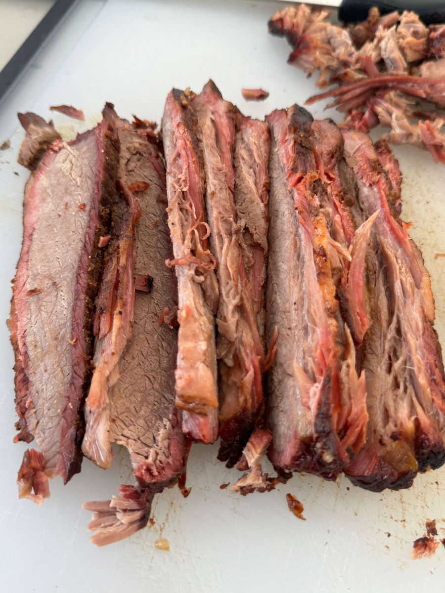 Sliced BBQ brisket on a cutting board