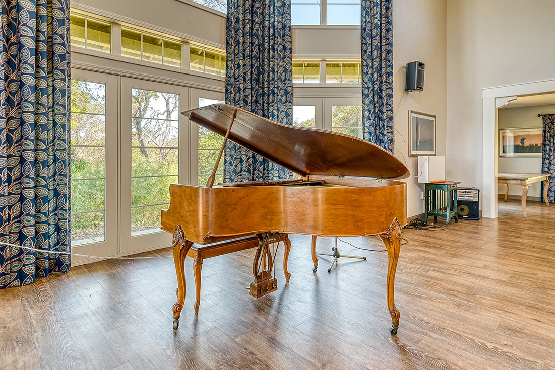 Interior view of a common area with a grand piano