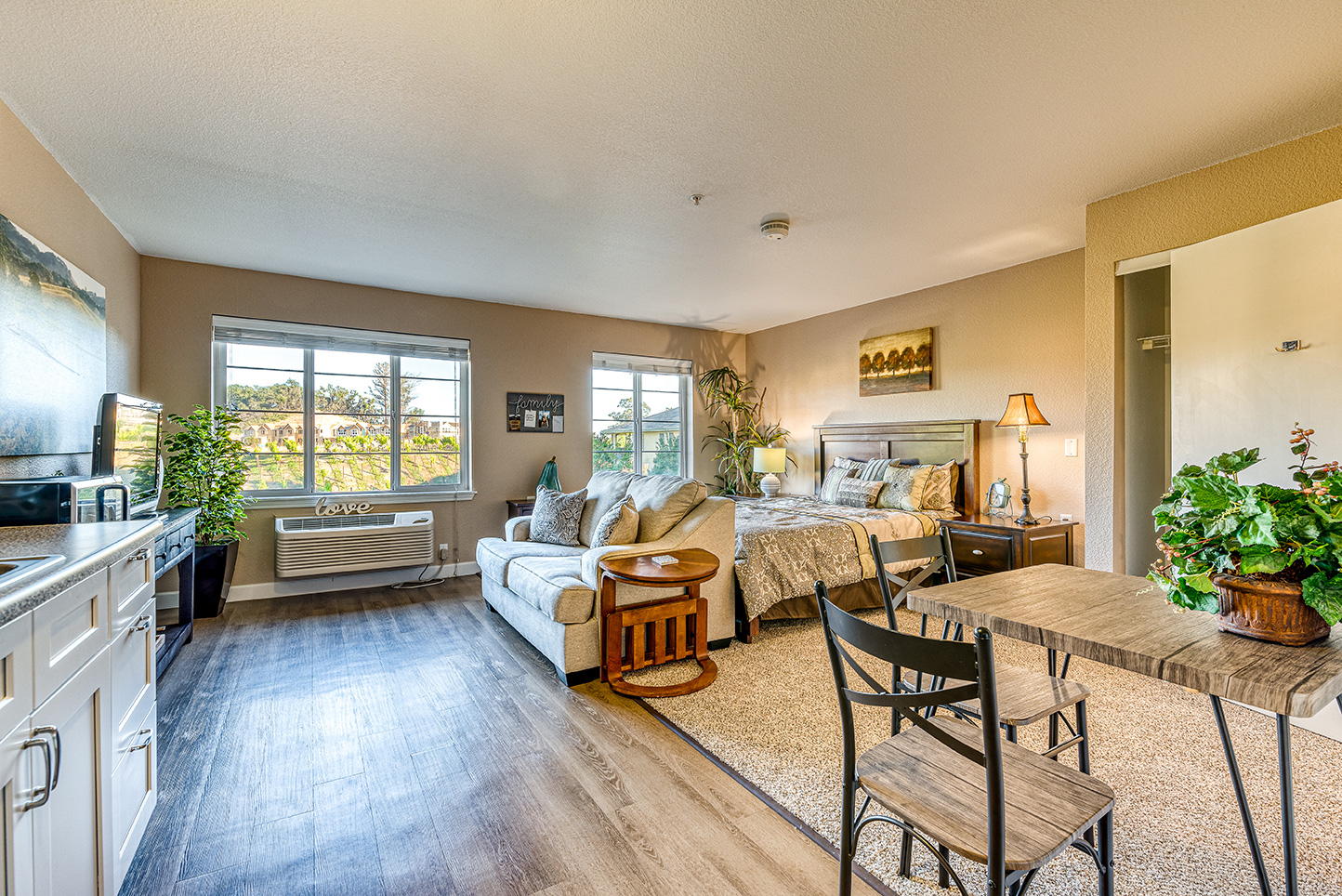 A cozy resident room featuring a bed and seating area