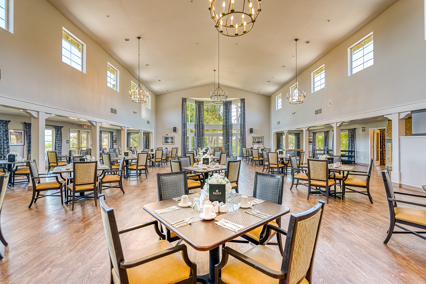 Bright dining room with tables and chairs set for meals