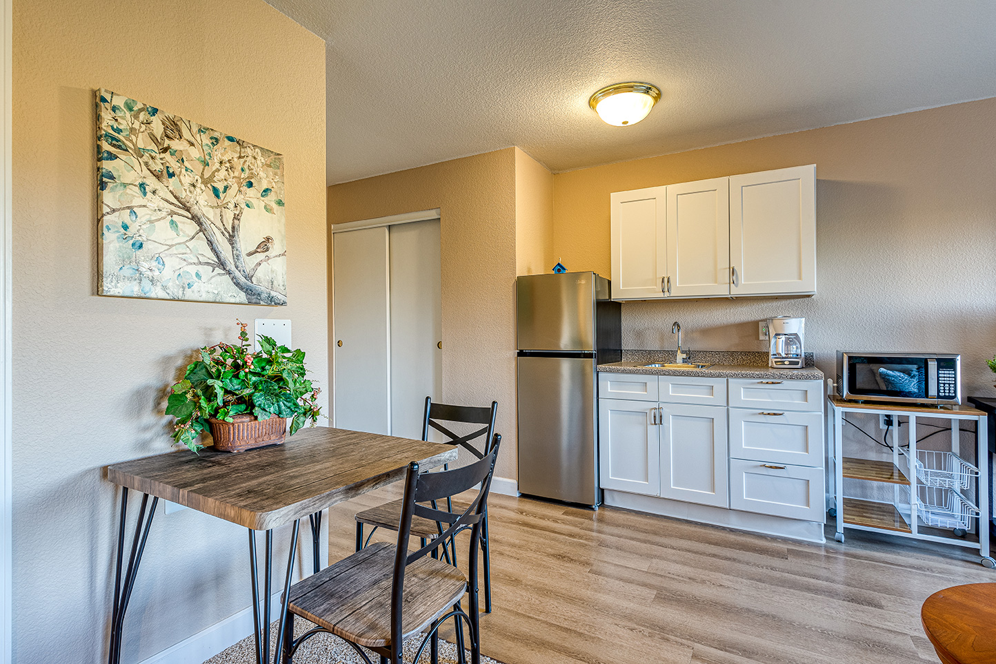 A cozy dining area with a small table and kitchenette