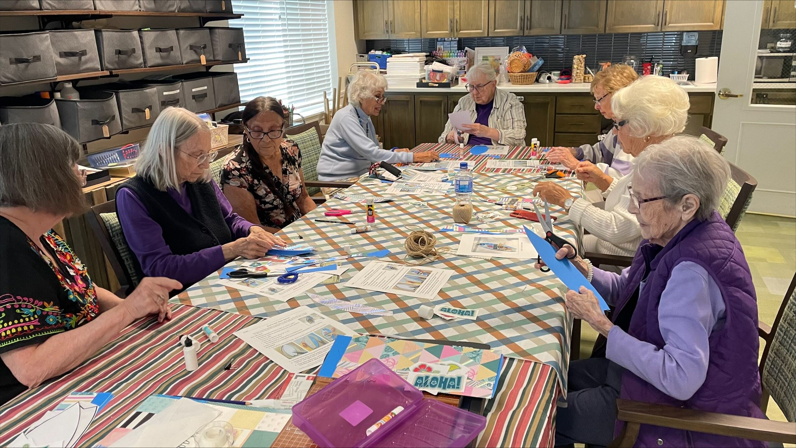 Residents engaged in a crafting activity around a table