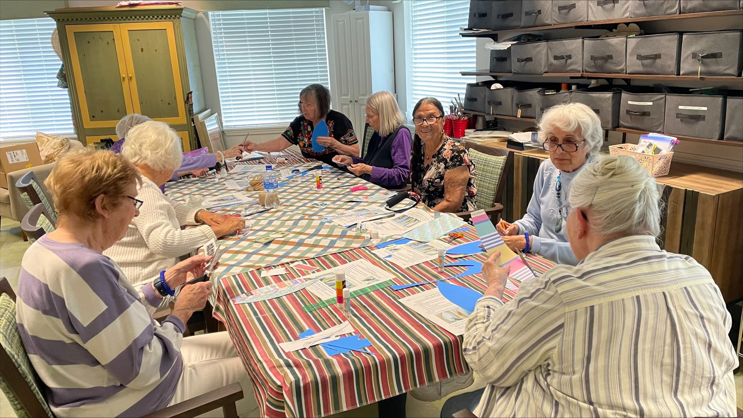 Residents engaged in a craft activity at a table