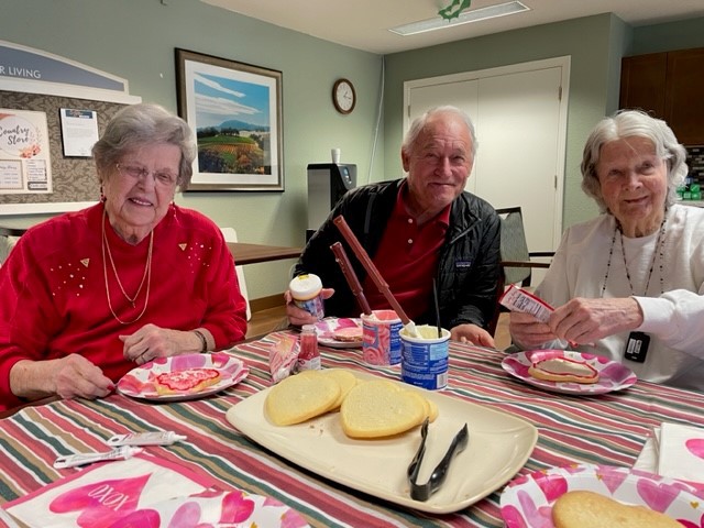 Residents enjoying a meal together with desserts