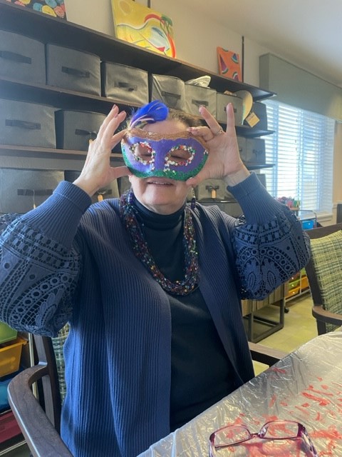 Resident wearing a colorful mask during an activity