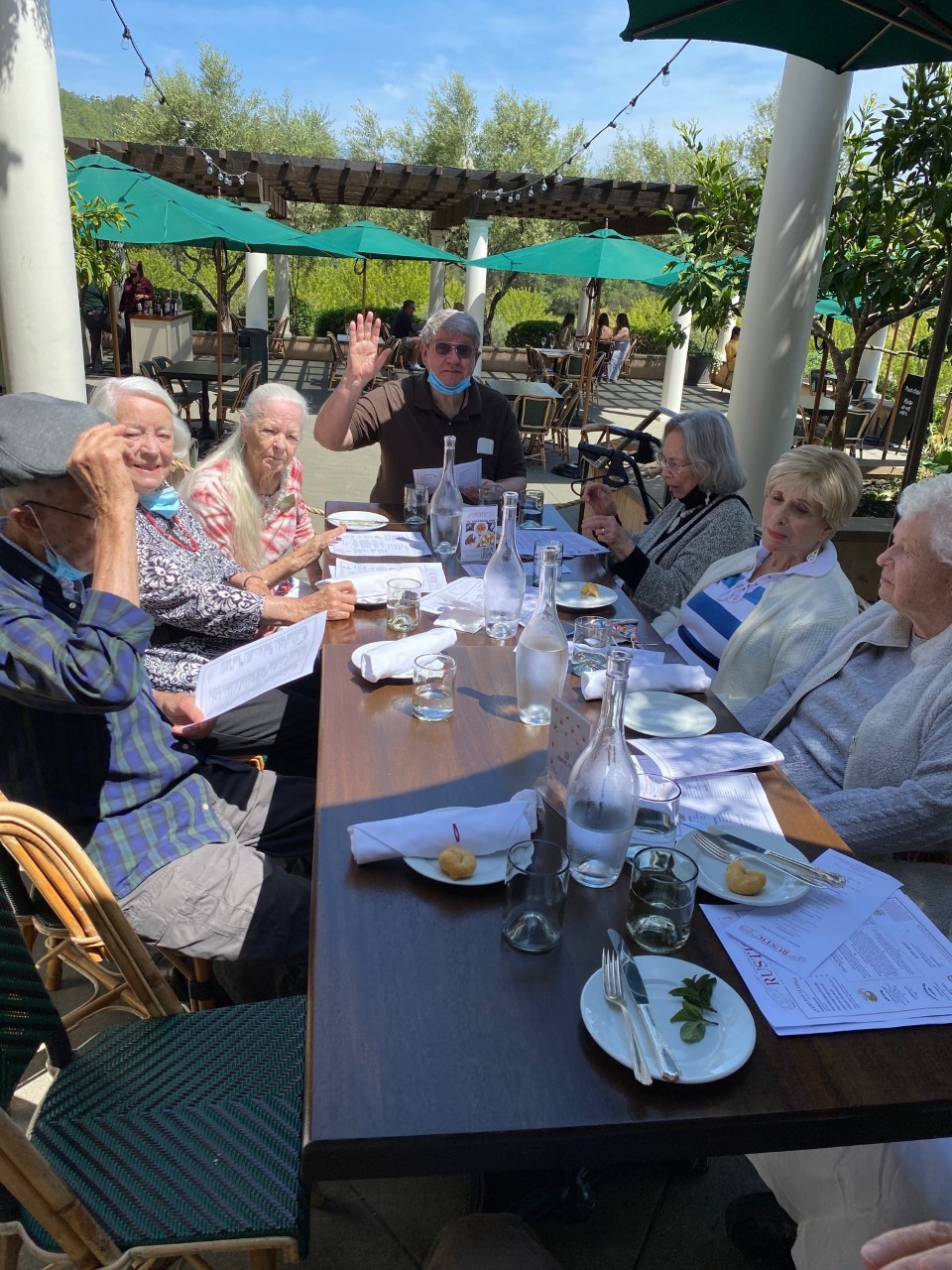 Residents enjoying lunch outdoors at a table