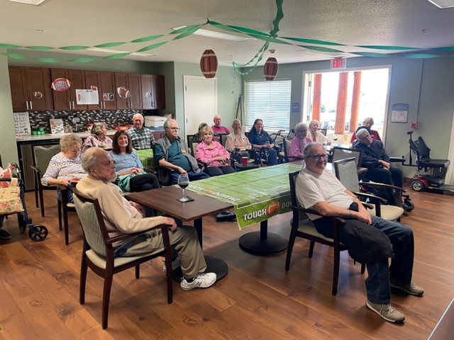 Residents engaged in a community gathering in a lounge