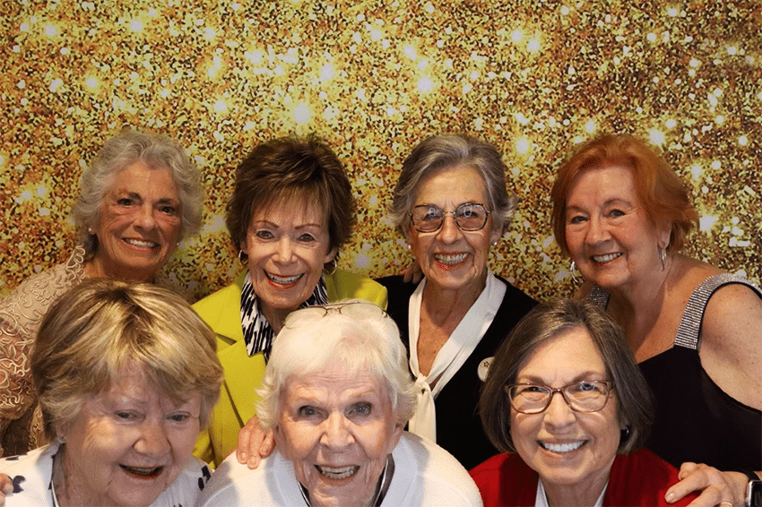 A joyful group of female residents in a celebratory setting