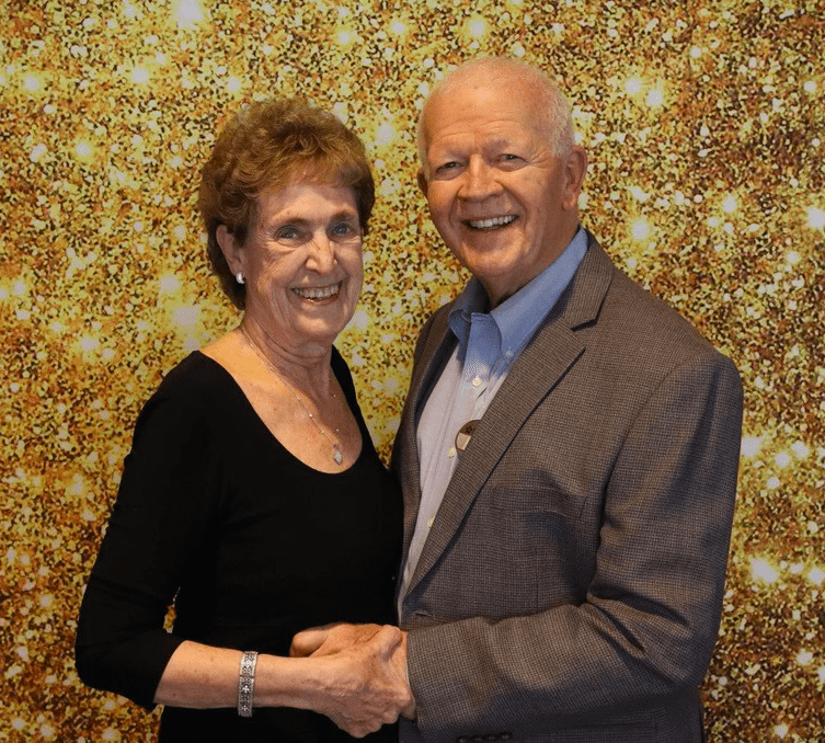 Two smiling residents posing together at a celebration